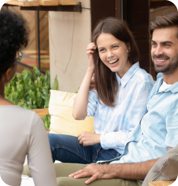 uma mulher e um homem olhando e rindo para outra mulher que esta de costas